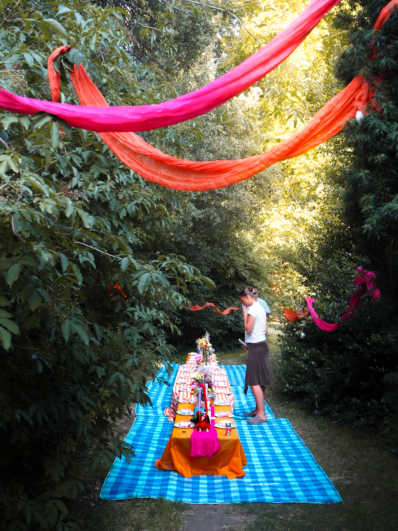 Long table set outdoors under draped fabric